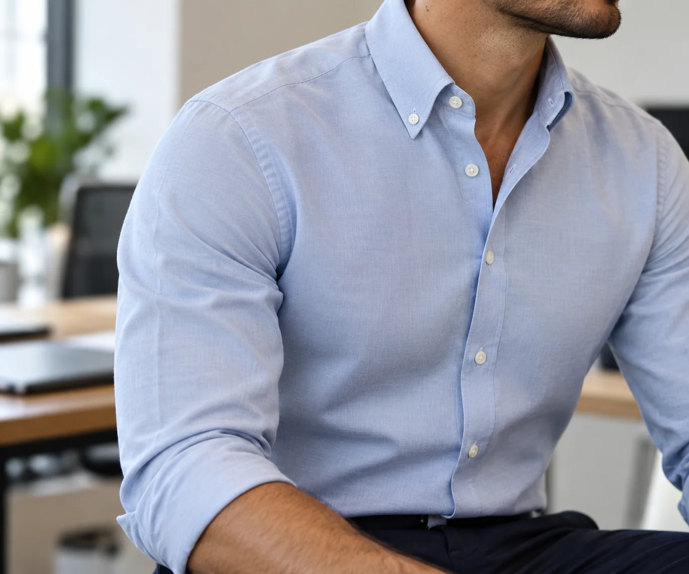 Close-up of a pale blue Oxford button-down shirt showing the collar, fabric and fit