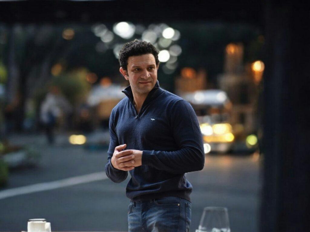 Man styling smart casual knitwear outdoors