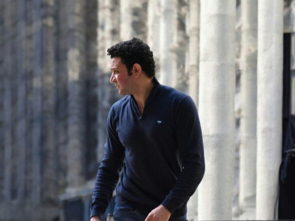 Man wearing a navy jumper outfit