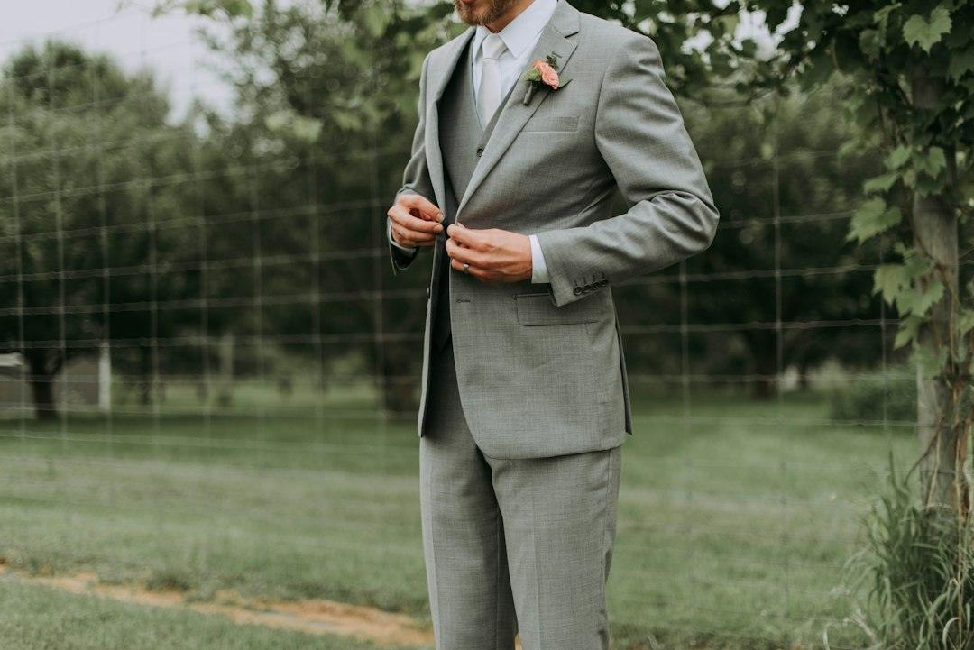 Man wearing a formal dark lounge suit with a shirt and tie